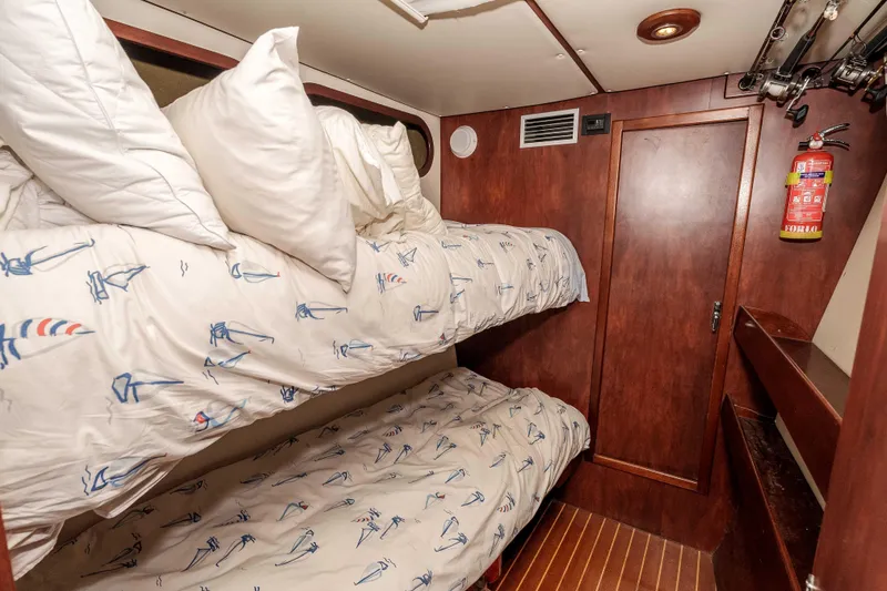 Slide: The Image of Cozy cabin with bunk beds in 2009 Kelsall KSS 58 yacht, featuring nautical-themed bedding. - 31