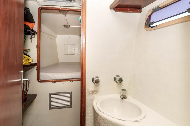 Slide: The Image of Interior of 2009 Kelsall KSS 58 yacht featuring a compact cabin and sink area. - 32