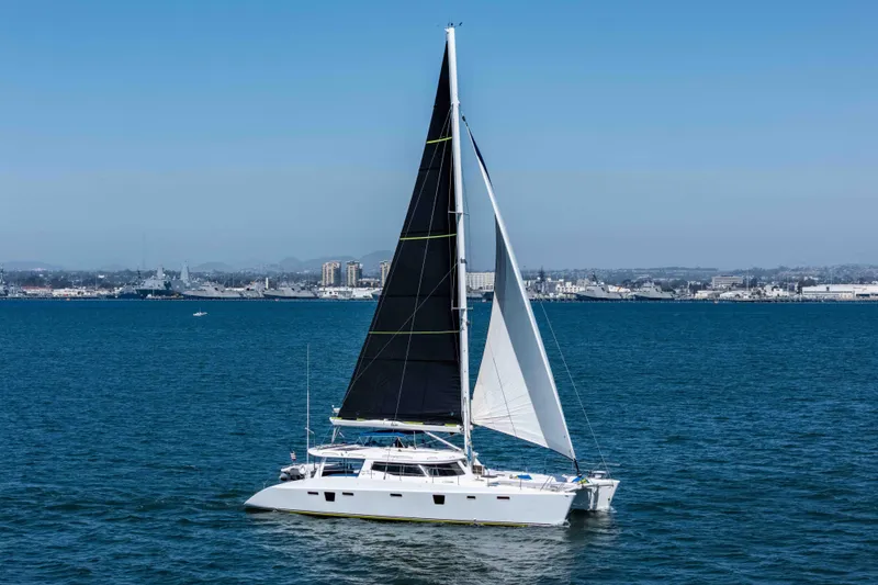 Slide: The Image of 2009 Kelsall KSS catamaran sailing on blue ocean with cityscape background. - 4