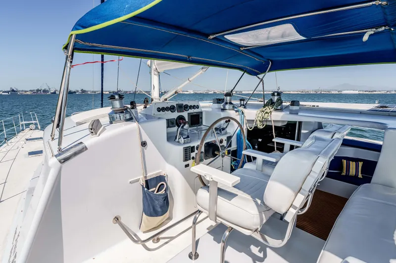 Slide: The Image of Helm of 2009 Kelsall KSS 58 catamaran with blue canopy and ocean view. - 5