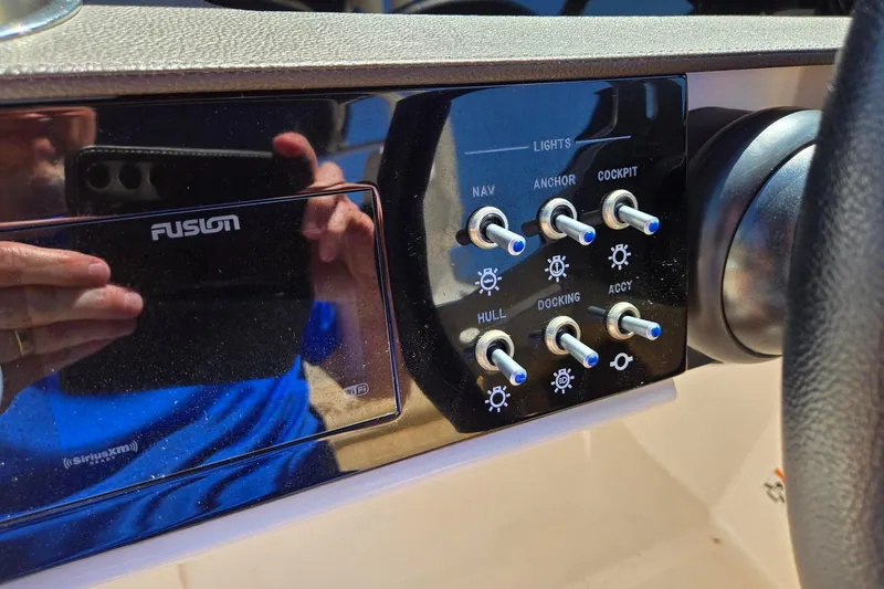 Slide: The Image of Control panel of a 2019 Sea Ray SDX 270 Outboard boat with light switches. - 12