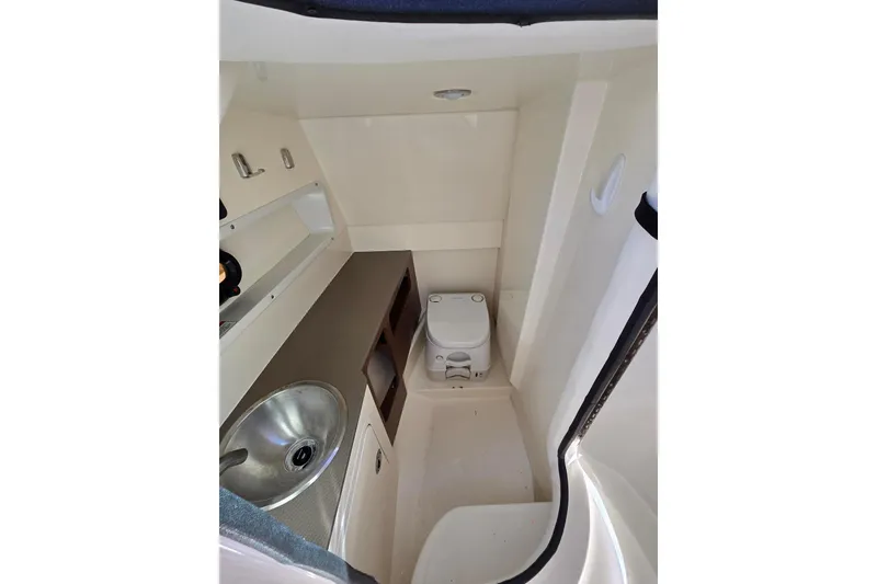 Slide: The Image of 2019 Sea Ray SDX 270 Outboard interior with sink and toilet. - 14