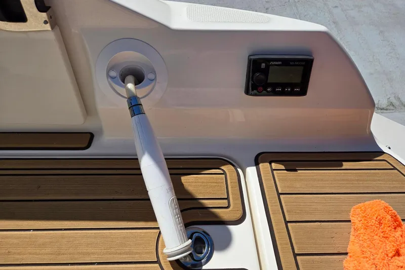 Slide: The Image of 2019 Sea Ray SDX 270 Outboard deck with shower hose and audio controls. - 16