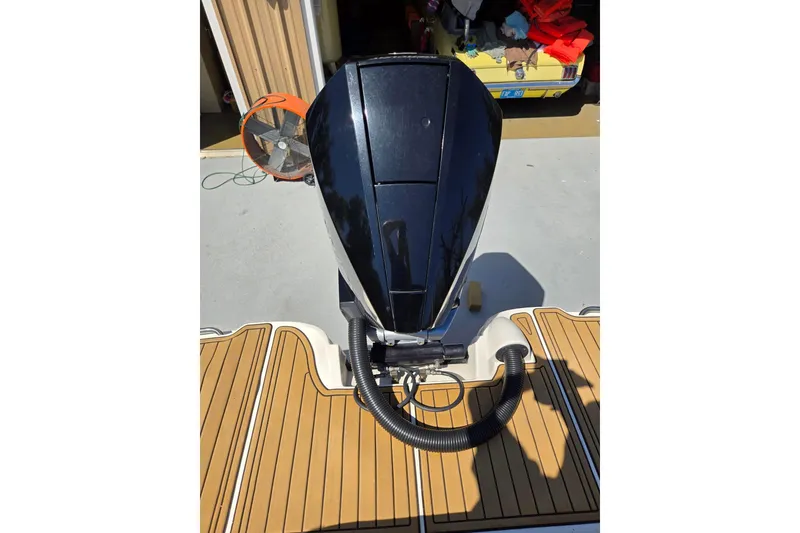 Slide: The Image of 2019 Sea Ray SDX 270 Outboard engine on teak deck, garage background. - 17