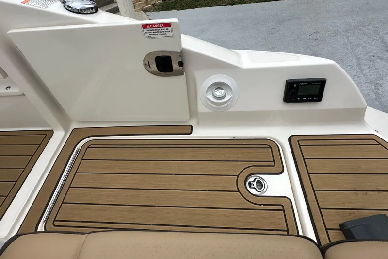Slide: The Image of 2019 Sea Ray SDX 270 Outboard deck with teak flooring and control panel. - 24