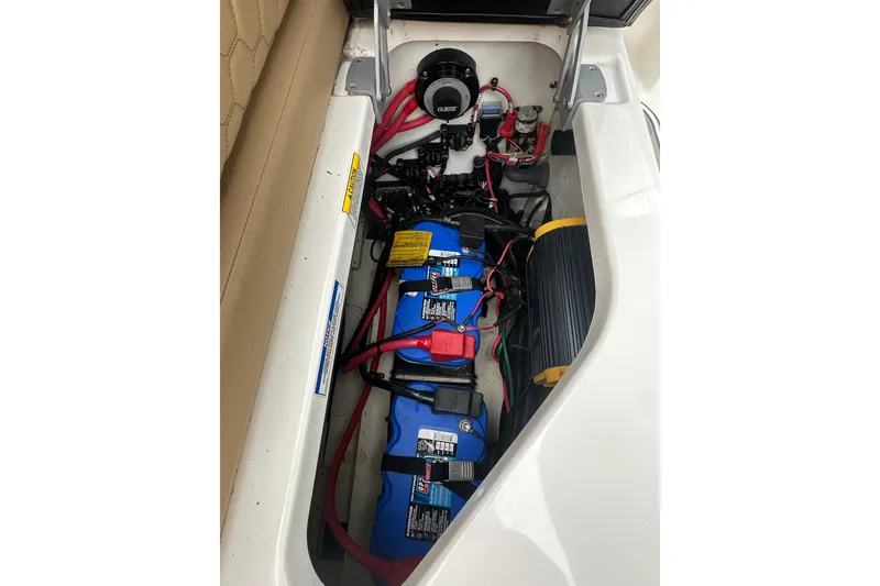Slide: The Image of 2019 Sea Ray SDX 270 Outboard battery compartment with wiring and components. - 25
