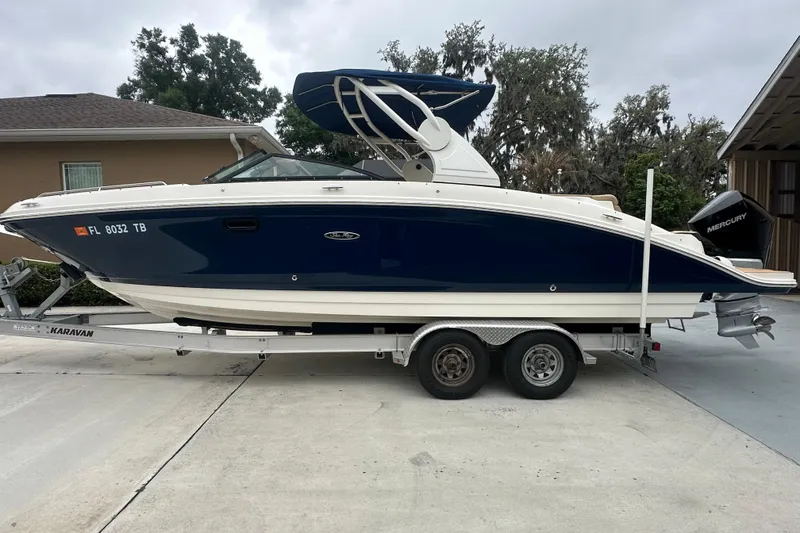 Slide: The Image of 2019 Sea Ray SDX 270 Outboard boat on trailer, parked in driveway. - 29