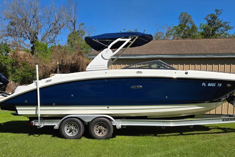 Slide: The Image of 2019 Sea Ray SDX 270 Outboard boat on trailer, parked on grass. - 3