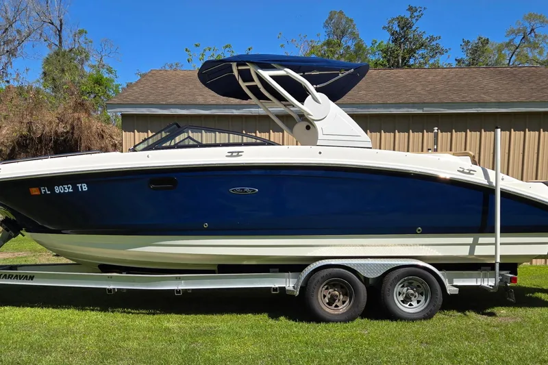 Slide: The Image of 2019 Sea Ray SDX 270 Outboard boat on trailer, parked on grass. - 6