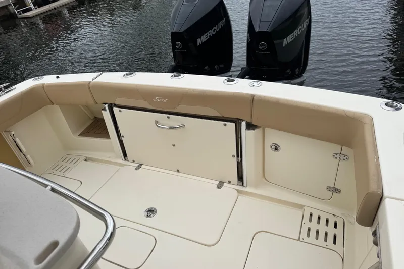 Slide: The Image of 2019 Scout 300 LXF boat interior with Mercury engines, docked on water. - 11