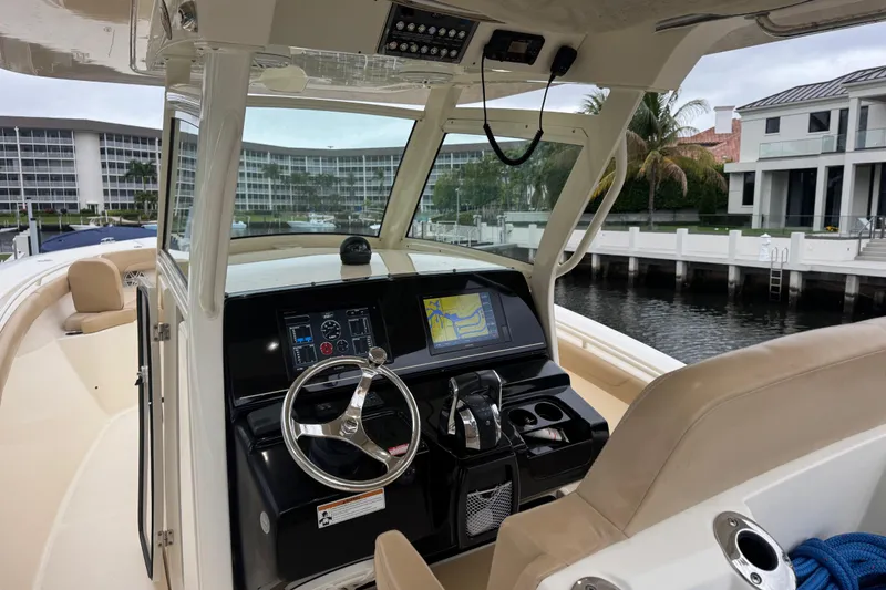 Slide: The Image of 2019 Scout 300 LXF boat cockpit with modern navigation system and luxurious seating. - 8