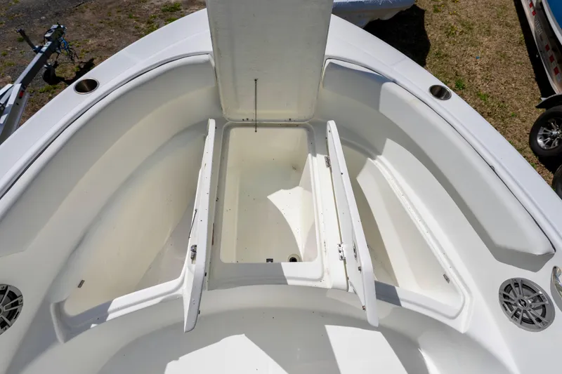 Slide: The Image of Open storage compartments on a 2020 Clearwater 2200 boat deck. - 11