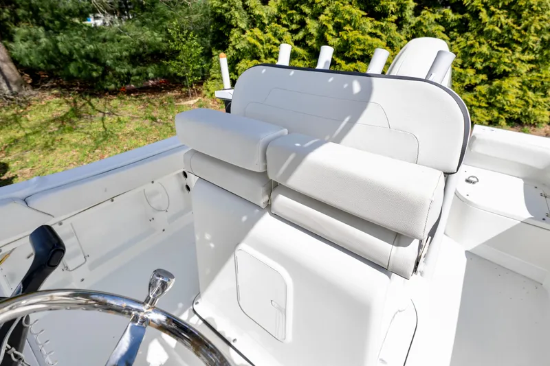 Slide: The Image of 2020 Clearwater 2200 boat interior with white seating and steering wheel. - 12
