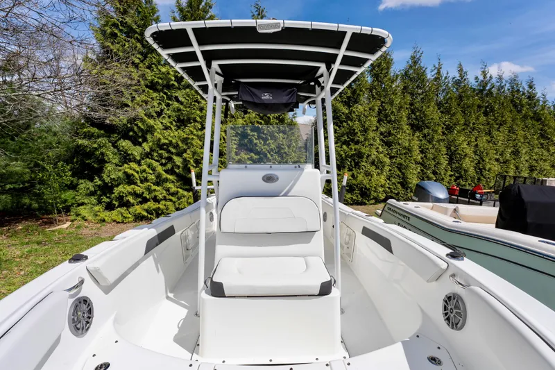Slide: The Image of 2020 Clearwater 2200 boat with T-top, white seating, and outdoor setting. - 9