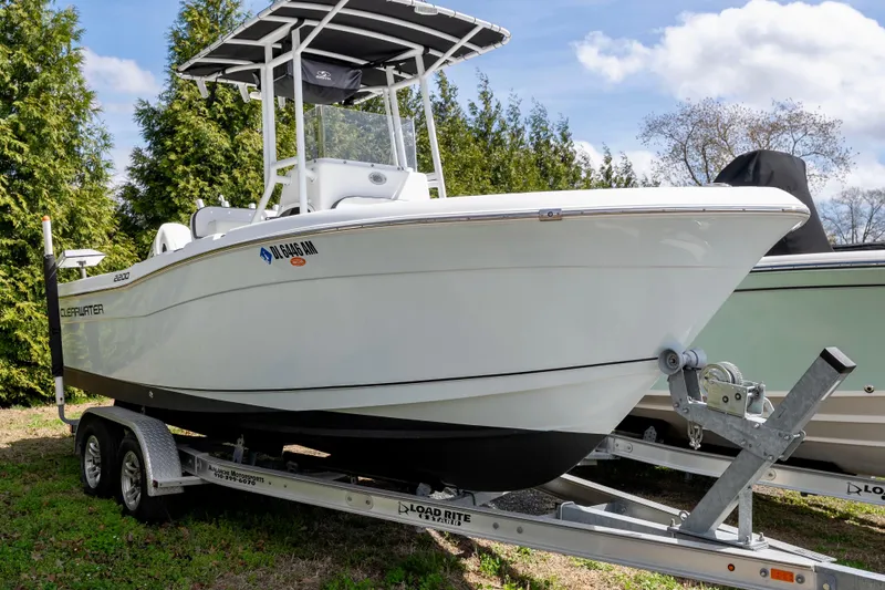 Slide: The Image of 2020 Clearwater 2200 boat with Suzuki engine on trailer in a spacious garage. - 2