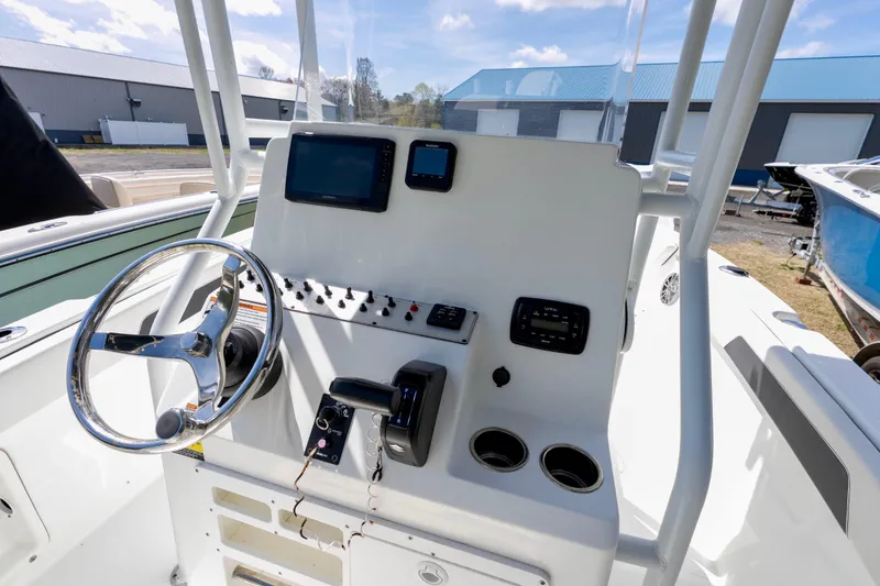 Slide: The Image of 2020 Clearwater 2200 boat interior with steering console and rod holders. - 7