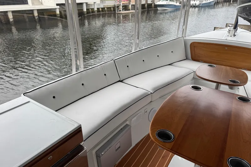 Slide: The Image of Luxurious interior of 2023 Duffy Bay Island 22 boat with elegant seating and wooden tables. - 10