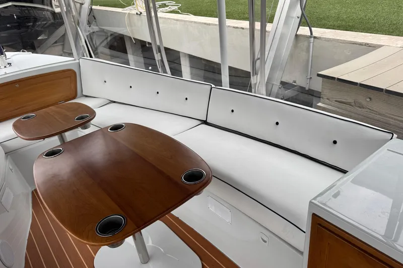 Slide: The Image of Elegant interior of 2023 Duffy Bay Island 22 with white seating and wooden tables. - 11