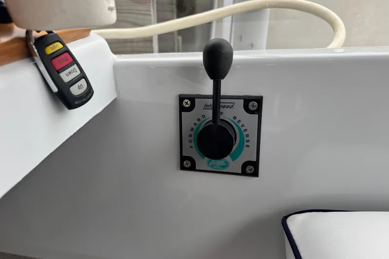 Slide: The Image of Control lever on 2023 Duffy Bay Island 22 boat dashboard, featuring forward and reverse settings. - 14