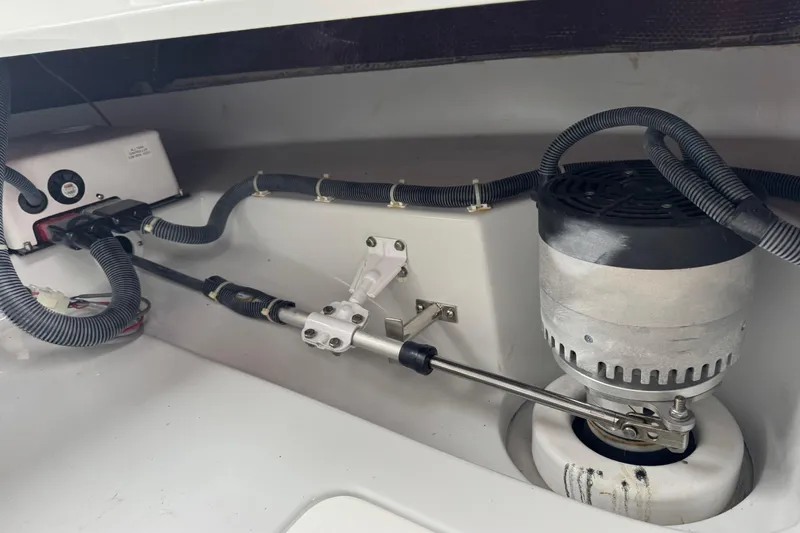 Slide: The Image of 2023 Duffy Bay Island 22 boat engine compartment with wiring and mechanical components. - 17