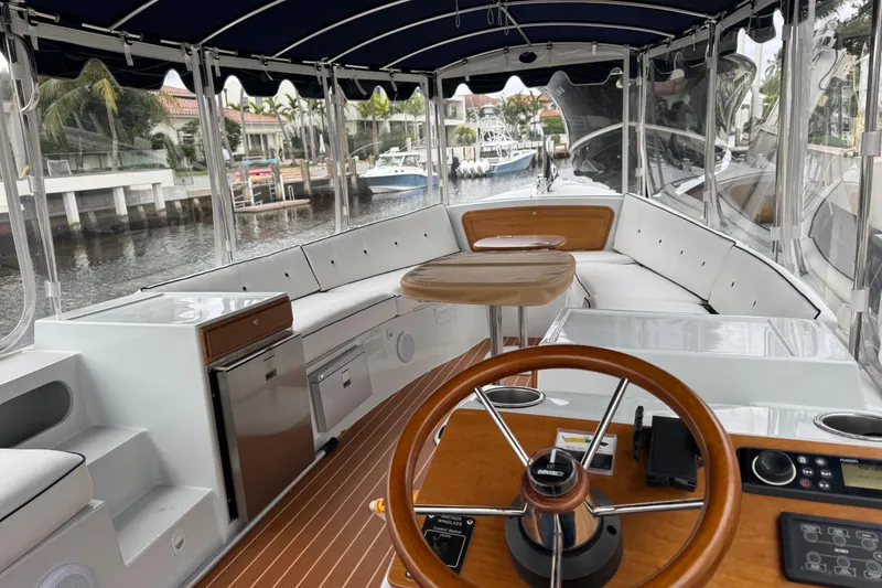 Slide: The Image of Interior of 2023 Duffy Bay Island 22 boat with elegant seating and steering wheel. - 5