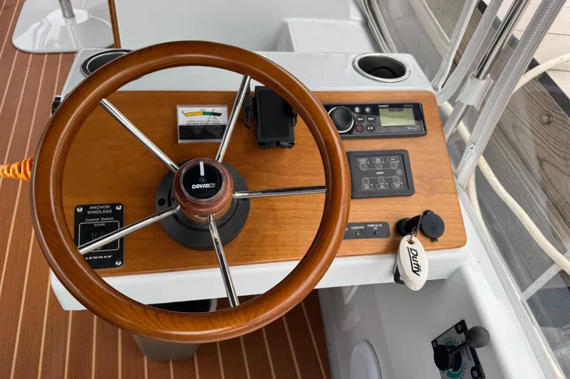 Slide: The Image of 2023 Duffy Bay Island 22 boat helm with wooden steering wheel and control panel. - 7
