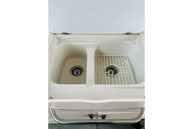 Slide: The Image of Double sink in 1988 Sea Ray 265 Sedan Bridge boat kitchen area. - 14