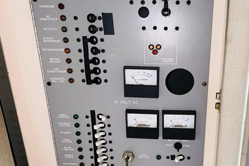 Slide: The Image of Electrical control panel of a 1988 Sea Ray 265 Sedan Bridge boat, featuring switches and gauges. - 15