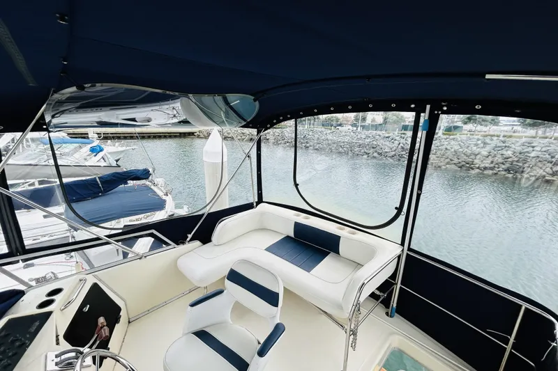 Slide: The Image of Interior view of 1988 Sea Ray 265 Sedan Bridge boat with seating and helm. - 7