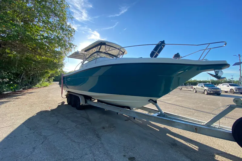 Slide: The Image of 2009 Century 3200 Offshore boat on trailer under clear blue sky. - 1