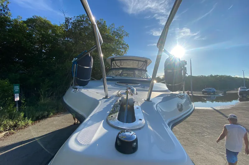 Slide: The Image of 2009 Century 3200 Offshore boat at dock, sunny day, surrounded by trees and water. - 15