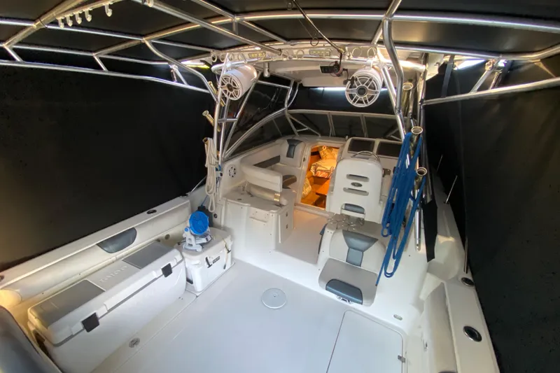Slide: The Image of Interior of a 2009 Century 3200 Offshore boat, featuring seating and fishing equipment. - 34