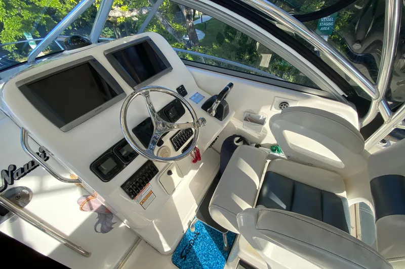 Slide: The Image of 2009 Century 3200 Offshore boat helm with dual screens and steering wheel. - 39