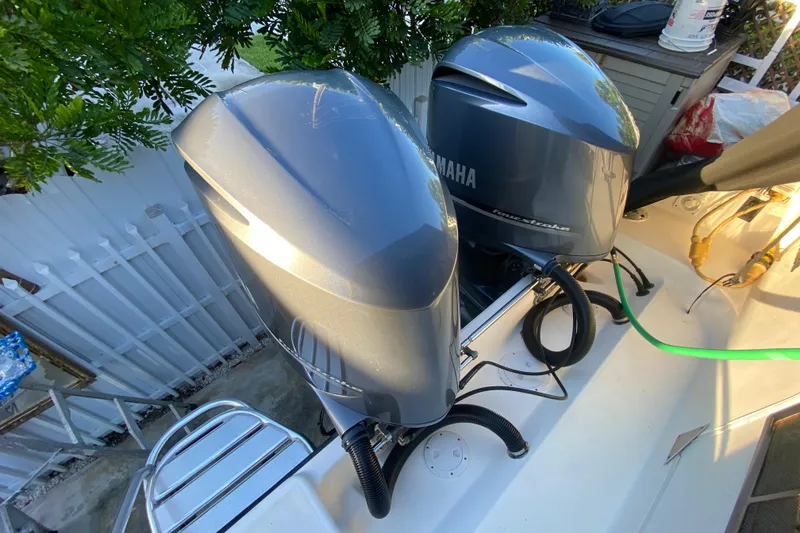 Slide: The Image of Twin Yamaha outboard engines on a 2009 Century 3200 Offshore boat, docked near foliage. - 43