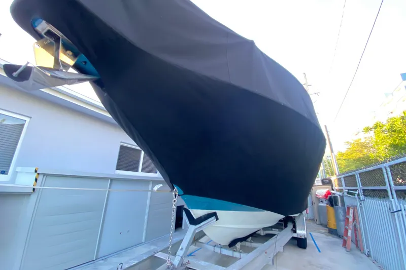 Slide: The Image of Covered 2009 Century 3200 Offshore boat on trailer, parked beside a building. - 8