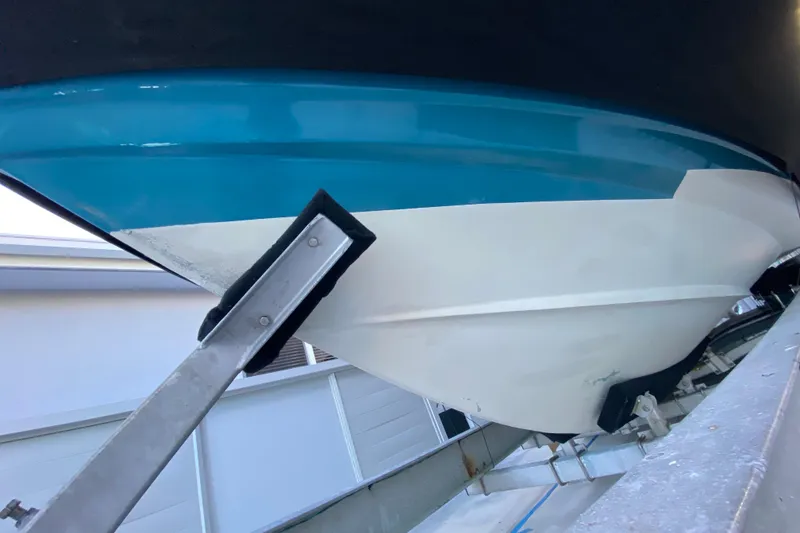 Slide: The Image of 2009 Century 3200 Offshore boat hull on trailer, showcasing blue and white design. - 9