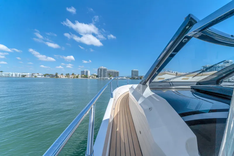 Slide: The Image of Luxury yacht Absolute 40 STL cruising on a sunny day, city skyline in background. - 16