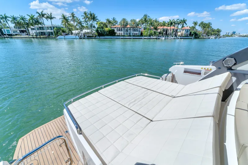 Slide: The Image of Luxurious 2017 Absolute 40 STL yacht with sunbathing deck, overlooking serene waterfront and palm trees. - 20