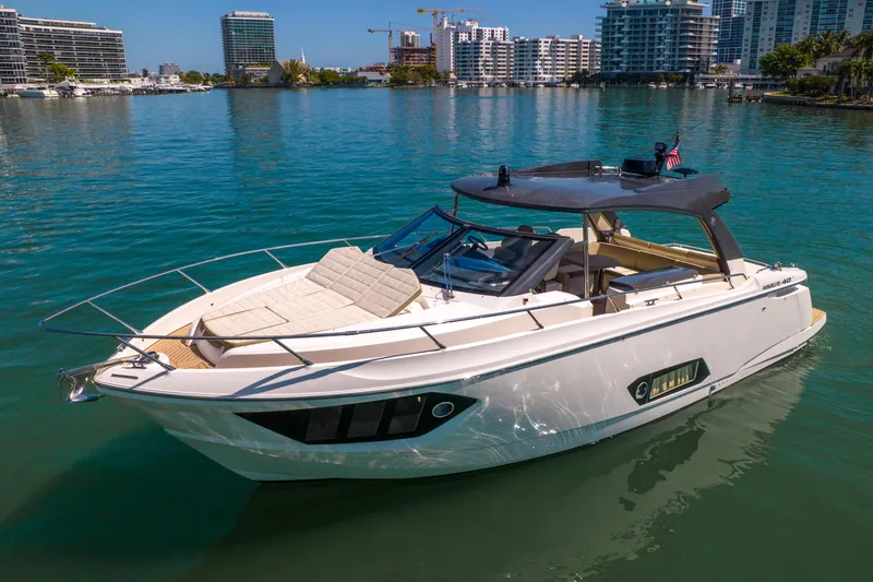 Slide: The Image of 2017 Absolute 40 STL yacht on calm water, surrounded by modern cityscape. - 3