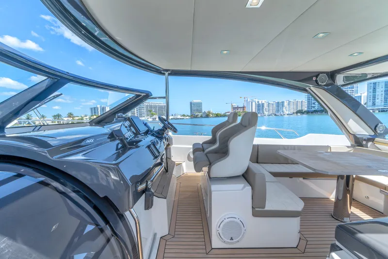 Slide: The Image of Luxurious 2017 Absolute 40 STL yacht interior with modern helm and seating, overlooking waterfront skyline. - 32