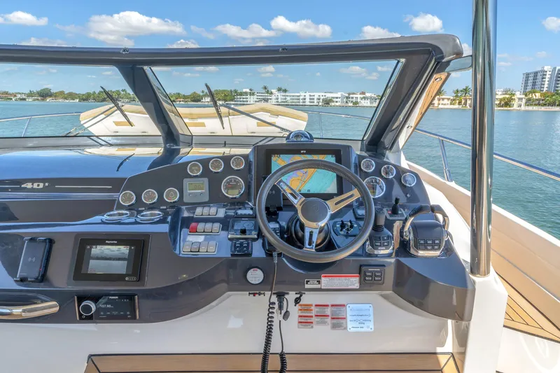 Slide: The Image of Cockpit of 2017 Absolute 40 STL yacht with navigation controls and scenic water view. - 33