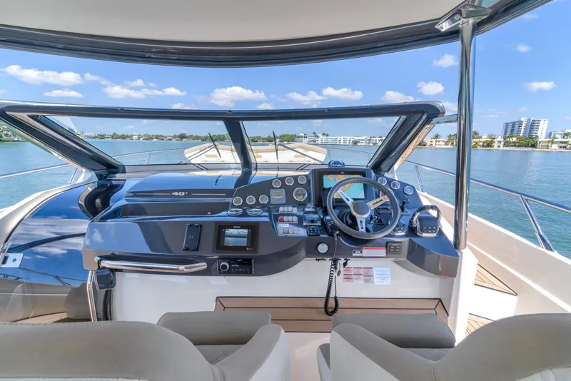 Slide: The Image of Cockpit view of 2017 Absolute 40 STL yacht with modern controls and scenic water backdrop. - 36