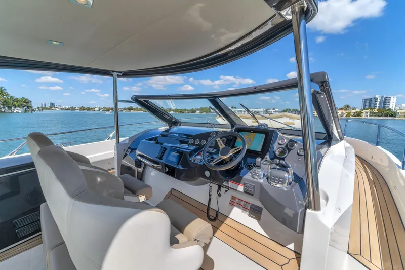 Slide: The Image of Luxurious helm of 2017 Absolute 40 STL yacht with modern controls and scenic water view. - 38