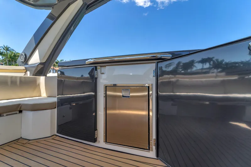 Slide: The Image of Luxurious 2017 Absolute 40 STL yacht interior with sleek cabinetry and seating under a clear blue sky. - 39