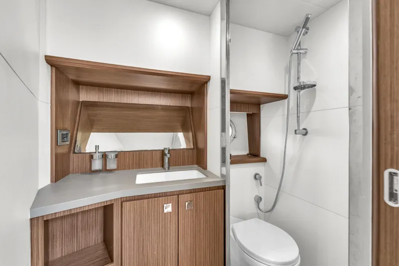 Slide: The Image of Luxurious bathroom in 2017 Absolute 40 STL yacht with modern fixtures and wood accents. - 53