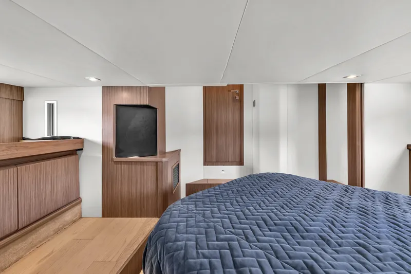 Slide: The Image of Luxurious interior of 2017 Absolute 40 STL yacht with modern wood paneling and cozy bedding. - 59