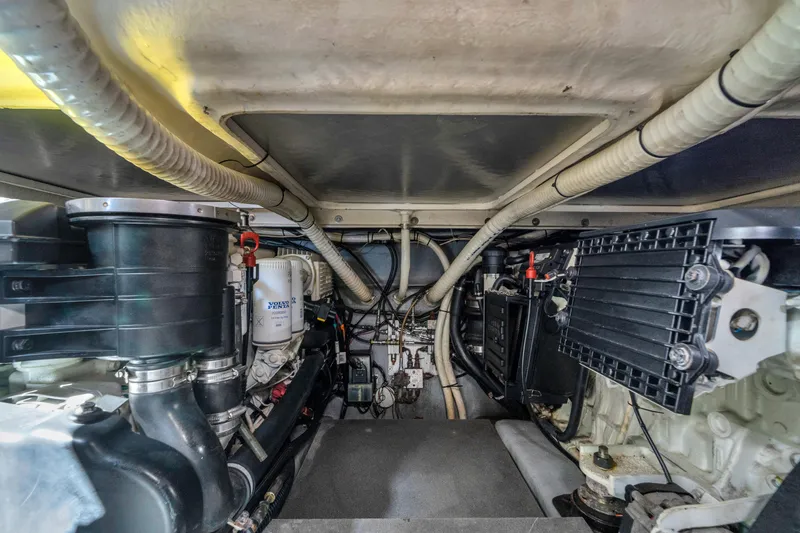 Slide: The Image of Engine room of a 2017 Absolute 40 STL yacht, showcasing mechanical components and wiring. - 62