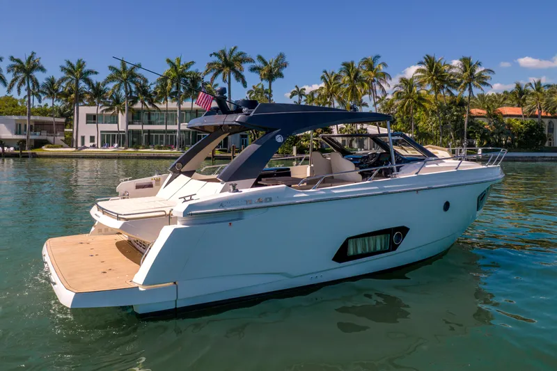 Slide: The Image of Luxury 2017 Absolute 40 STL yacht docked near palm trees and waterfront homes. - 65