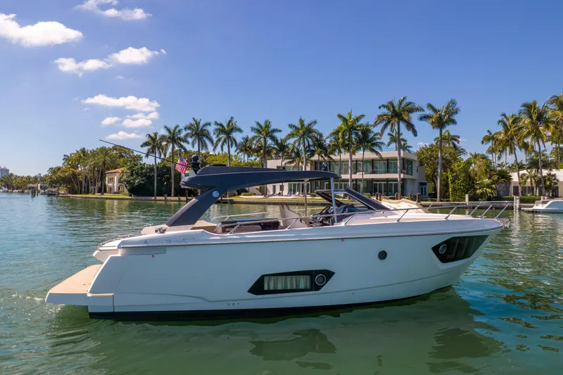 Slide: The Image of 2017 Absolute 40 STL yacht cruising near waterfront homes and palm trees. - 66