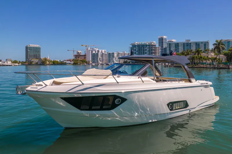 Slide: The Image of 2017 Absolute 40 STL yacht on calm water with city skyline background. - 69
